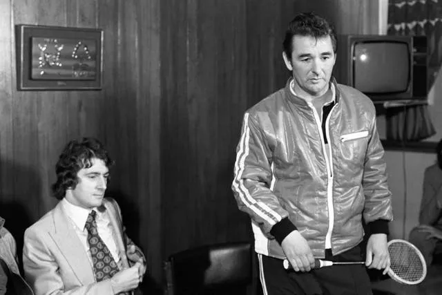Clough (right) presented Francis to the media holding a squash racket 