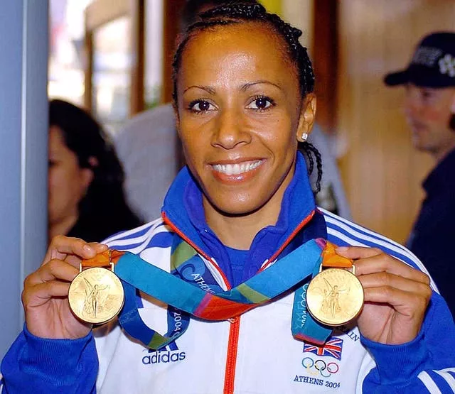 Kelly Holmes shows off her Olympic gold medals from Athens