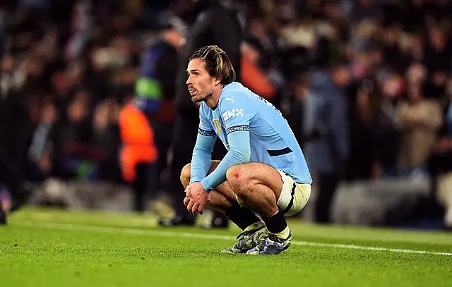 Manchester City’s Jack Grealish crouches down in dejection after his side's draw with Feyenoord