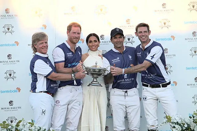 Meghan and Harry on the podium with Harry's polo team-mates