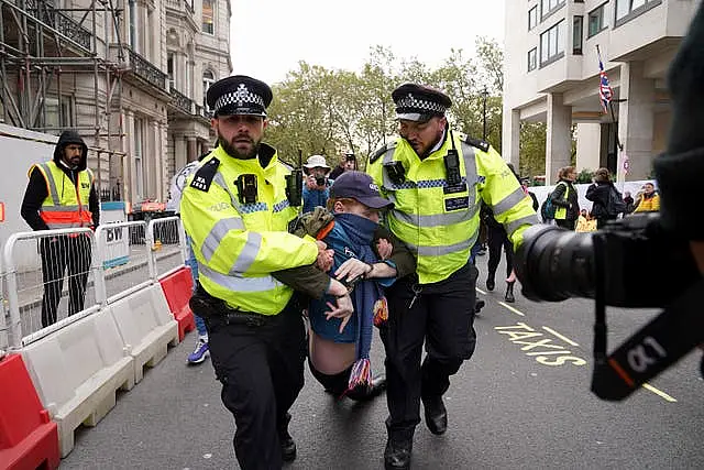 Police remove an activists during the protest 