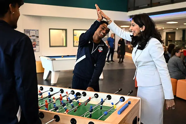 Home Secretary Suella Braverman plays a game of table football during a visit to Bolton Lads and Girls Club in Bolton, Greater Manchester 