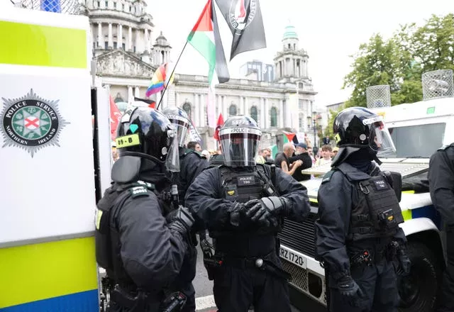 Riot police separate anti immigration protesters from anti-racist demonstrators in Belfast