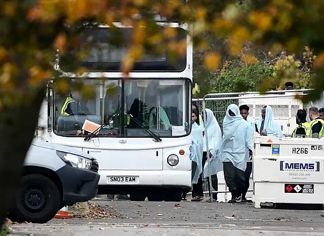 A view of people thought to be migrants at the Manston immigration short-term holding facility located at the former Defence Fire Training and Development Centre in Thanet, Kent