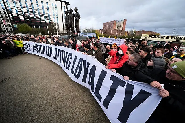 Manchester United fans protest against ticket pricing ahead of the game, displaying a banner reading 'stop exploiting loyalty'.