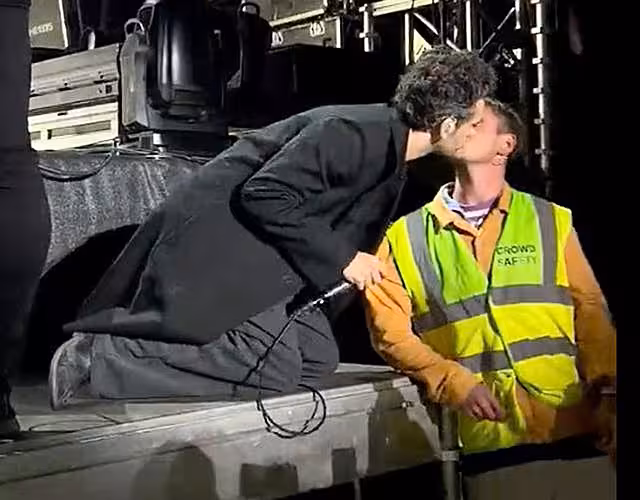 Matty Healy kisses crowd safety worker