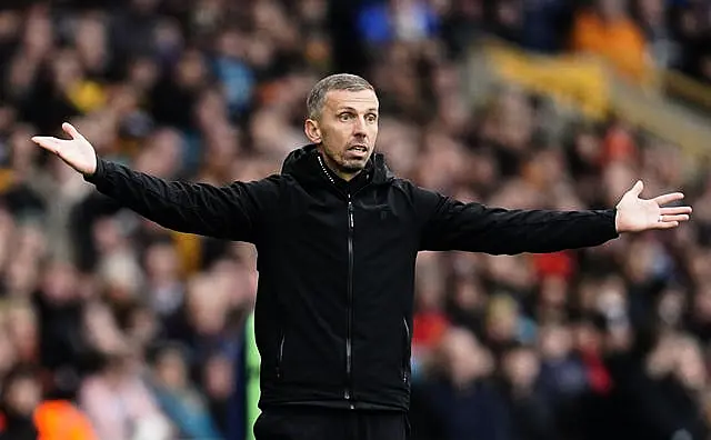 Former Wolves head coach Gary O'Neil stands arms outstretched on the touchline