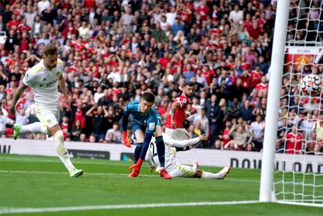 Bruno Fernandes wheels away to celebrate as he scores past Leeds goalkeeper Illan Meslier