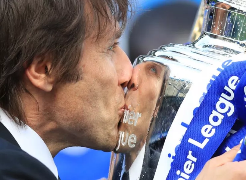 Antonio Conte kisses the Premier League trophy after winning it with Chelsea