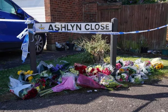 Floral tributes near to the road sign for Ashlyn Close