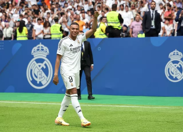 Kylian Mbappe waves at his Real Madrid unveiling