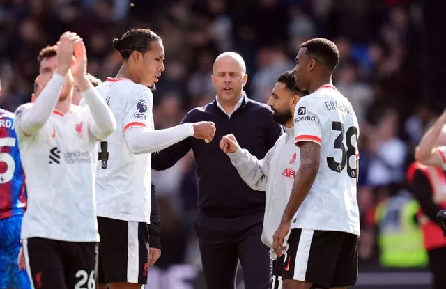 Arne Slot celebrates with his players at the end of the game