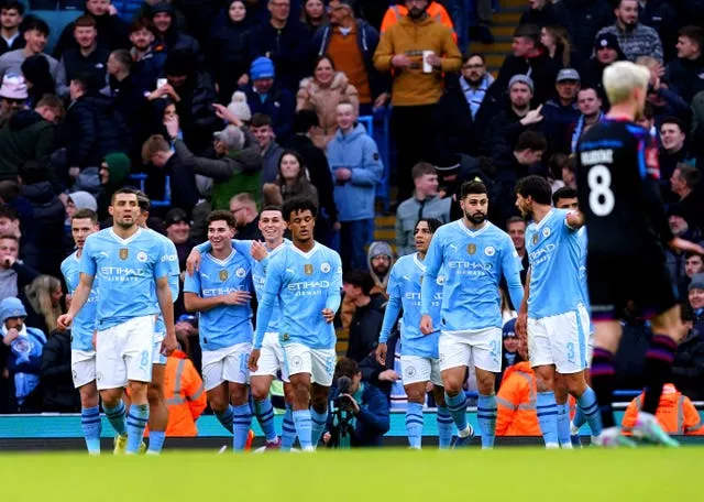 Manchester City celebrate after Julian Alvarez, third left, scored their second goal against Huddersfield