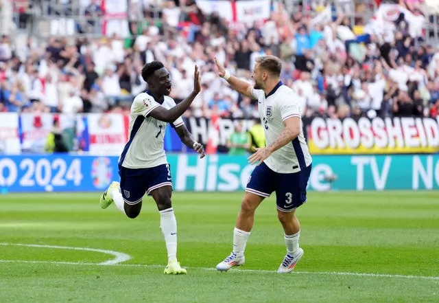 England’s Bukayo Saka (left) celebrates with Luke Shaw after scoring against Switzerland at Euro 2024