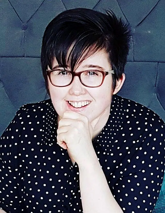 Lyra Mckee wearing a white polka dot top and smiling