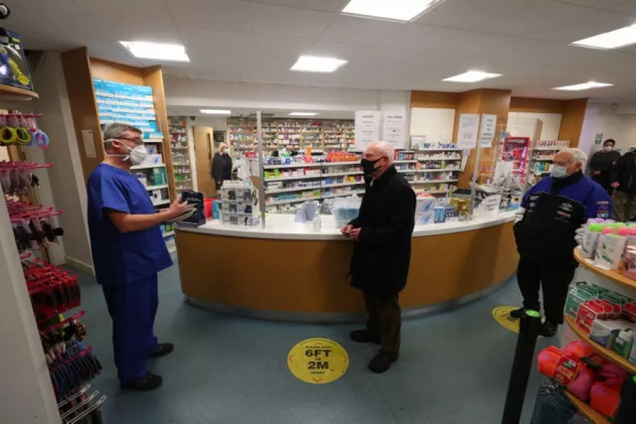 Pharmacist Andrew Hodgson (left) speaks to Robert Salt (centre), 82, before he receives an injection of the coronavirus vaccine at Andrews Pharmacy in Macclesfield