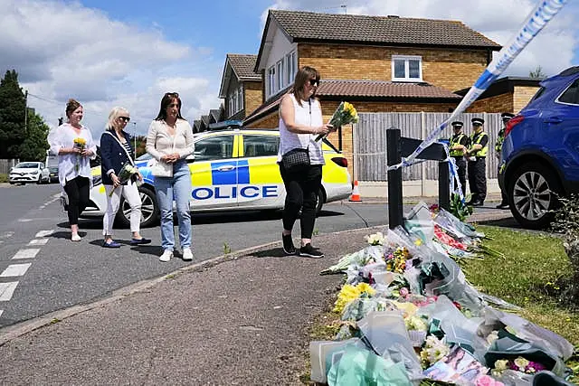 People leave flowers at Ashlyn Close, Bushey (Jonathan Brady/PA)