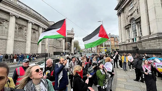 Protesters gathered outside Trinity College on Saturday where the students had set up camp 