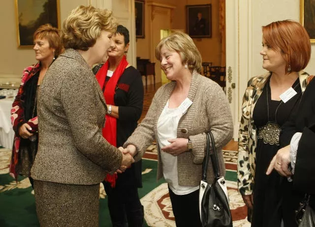 President Mary McAleese speaks in 2010 to Margo McCrory whose son was injured during the Omagh bombing