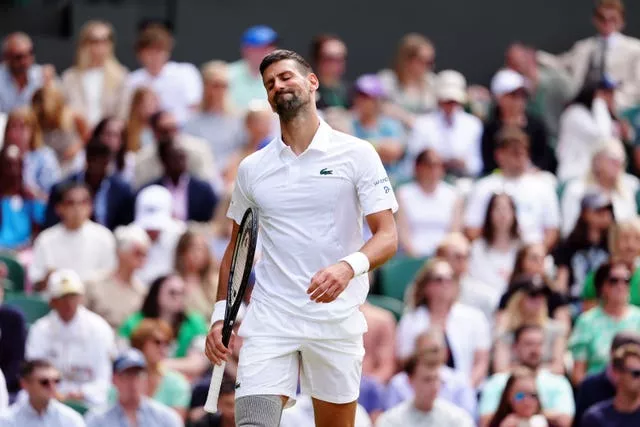 Novak Djokovic tilts his head as he reacts on the court