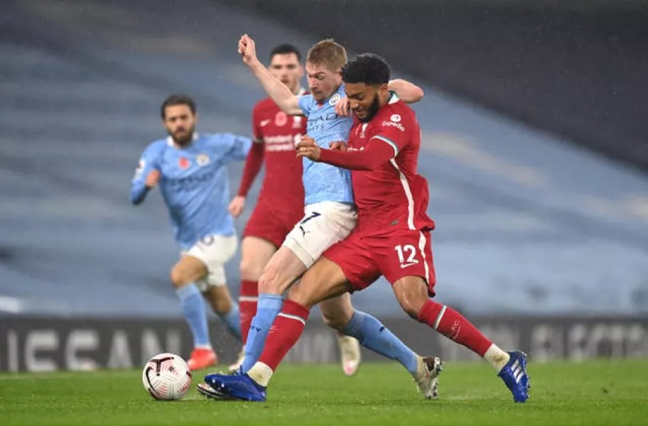 Manchester City’s Kevin De Bruyne and Liverpool’s Joe Gomez battle for the ball