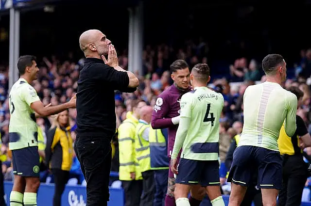 Manchester City manager Pep Guardiola celebrates in front of fans