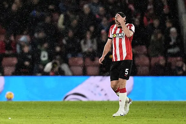 Jack Stephens leaves the pitch after being shown a red card