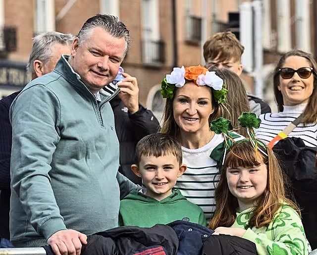 Derek, Eoin, Paula, and Emma Donnelly, from Dublin wait for the St Patrick’s Day Parade in Dublin.