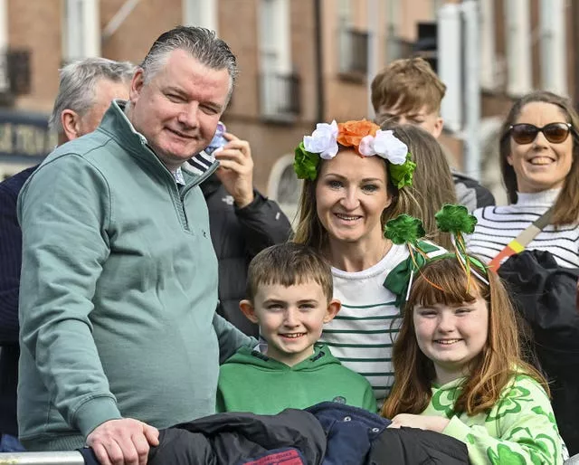 Derek, Eoin, Paula, and Emma Donnelly, from Dublin wait for the St Patrick’s Day Parade in Dublin.