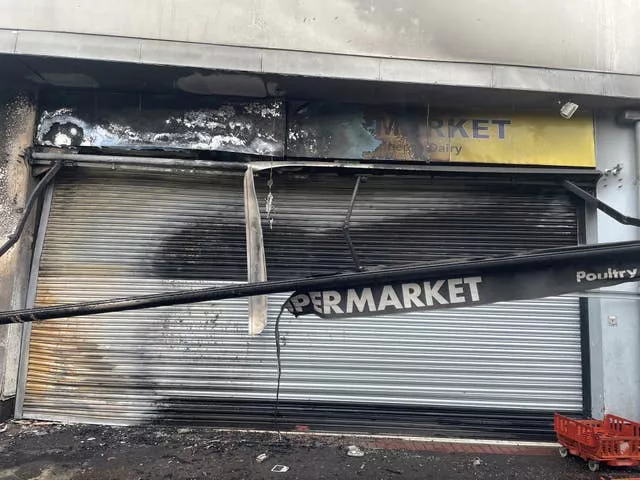 The front of a supermarket damaged by fire