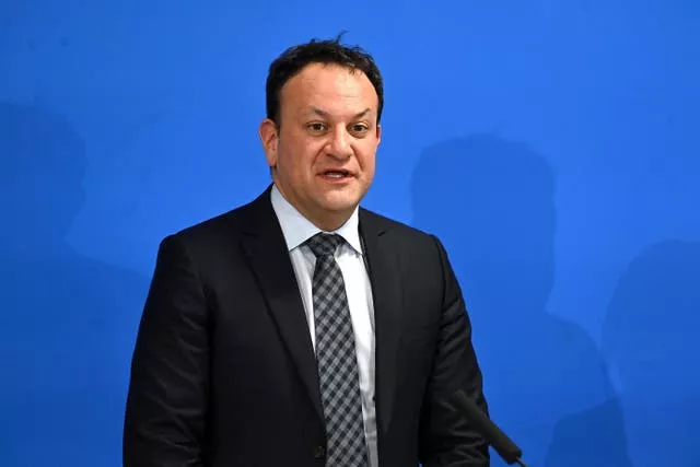 Leo Varadkar in black suit before blue background