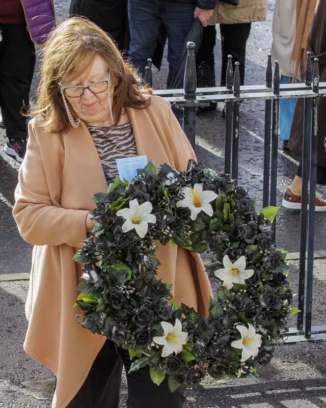 Dympna Kerr, the sister of Columba McVeigh, lays the wreath during the 17th annual All Souls Silent Walk for the Disappeared at Stormont