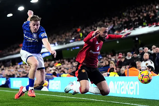 Ipswich’s Liam Delap (left) battles for the ball with Manchester United’s Noussair Mazraoui