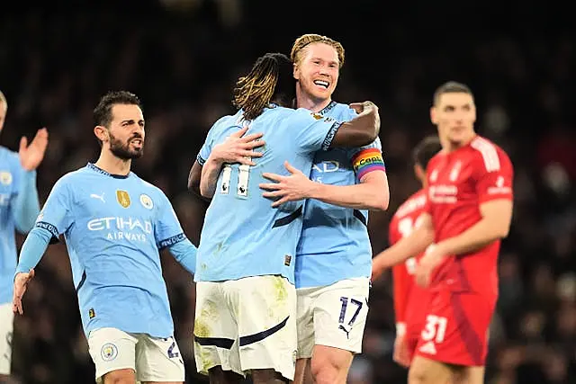 Manchester City’s Kevin De Bruyne is hugged by Jeremy Doku as he celebrates scoring against Nottingham Forest