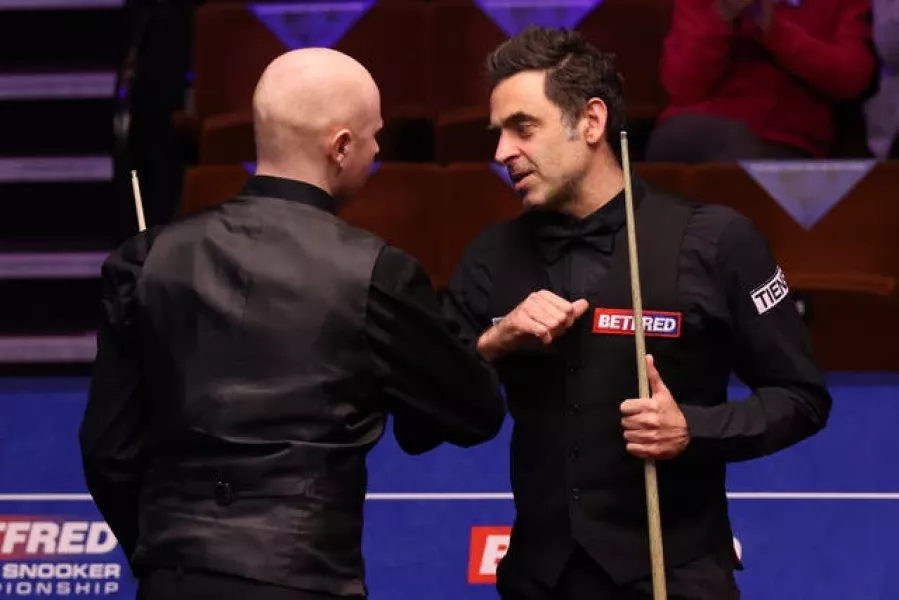 Ronnie O’Sullivan (right) bumps elbows with Anthony McGill