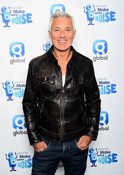 Martin Kemp smiling, with his hands in his pockets.