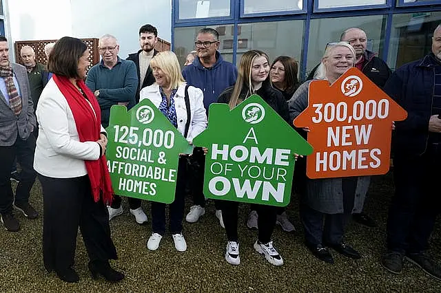 Sinn Fein leader Mary Lou McDonald with people holding placards about housing in Dublin