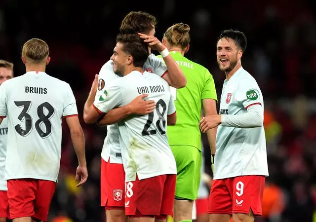 FC Twente players celebrate following the draw at Old Trafford 