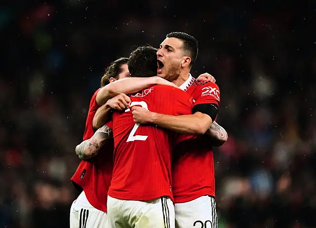 Manchester United’s Marcel Sabitzer, Victor Lindelof and Diogo Dalot celebrate their penalty shoot-out victory over Brighton in Sunday's FA Cup final