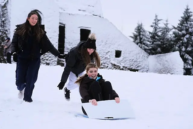 Nessa Wardick, from Templeogue, gets a push from her friends Faye Tierney (right) and Abbie Turner (left) at the Hell Fire club on Montpelier in Dublin ahead of a Status Orange low temperature warning issued for most counties on Wednesday night