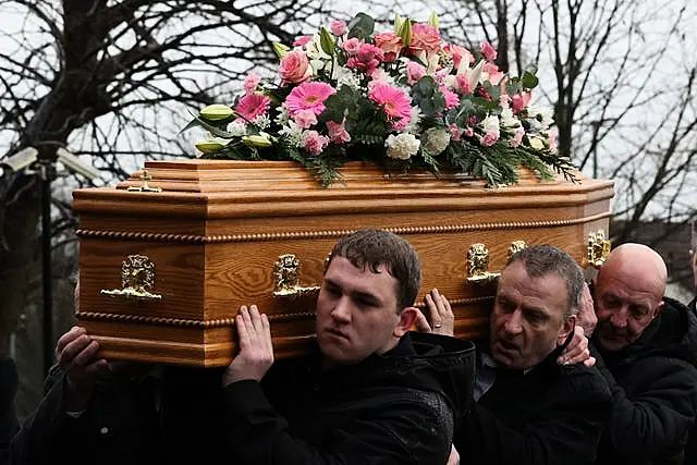 The coffin is carried into the funeral of Karen Cummings