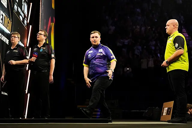 Luke Littler, left, and Michael van Gerwen on stage