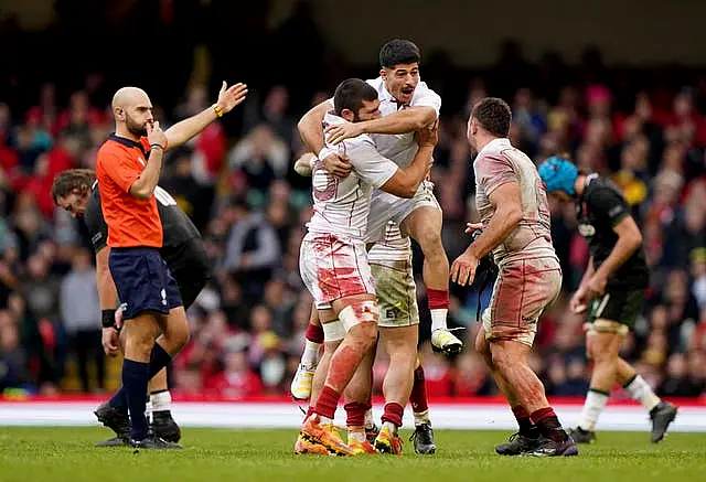 Sandro Mamamtavrishvili, left, Luka Matkava, centre, and Beka Saghinadze, right, celebrate victory 