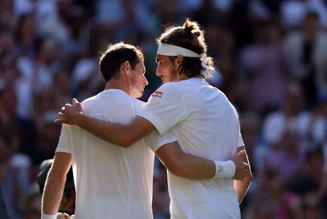 Stefanos Tsitsipas and Andy Murray (left) embrace after their five-set thriller