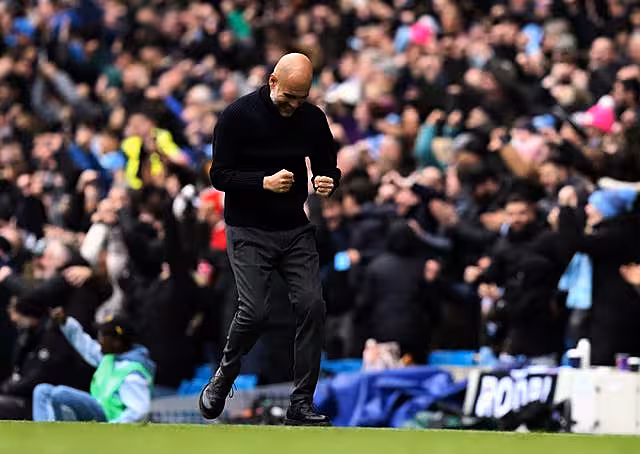 Manchester City manager Pep Guardiola celebrates the opening goal scored by Erling Haaland