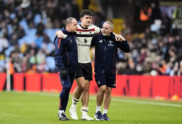 Harry Maguire is helped off the pitch