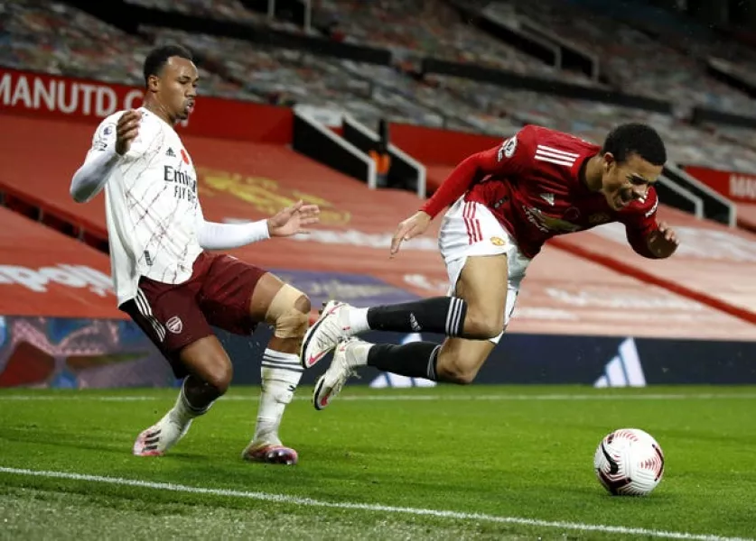 Gabriel Magalhaes avoids a second booking for a foul on Mason Greenwood