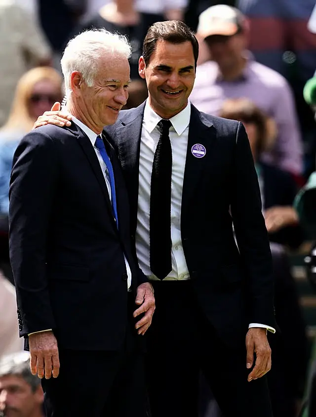 Former Wimbledon champions John McEnroe (left) and Roger Federer 