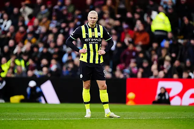 Manchester City’s Erling Haaland stands dejected with his hands on his hips at Villa Park