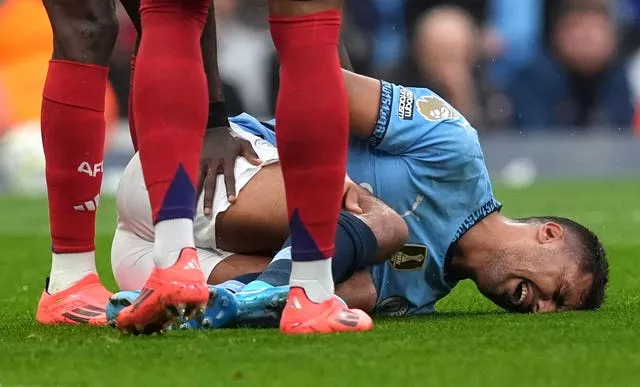 Manchester City’s Rodri lies injured before being substituted during a Premier League match against Arsenal